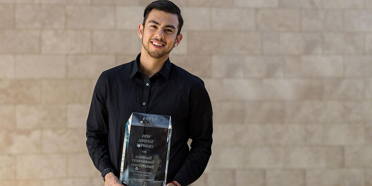 Diego Perez standing with trophy