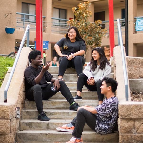 Students chatting on the stairs of Global Village