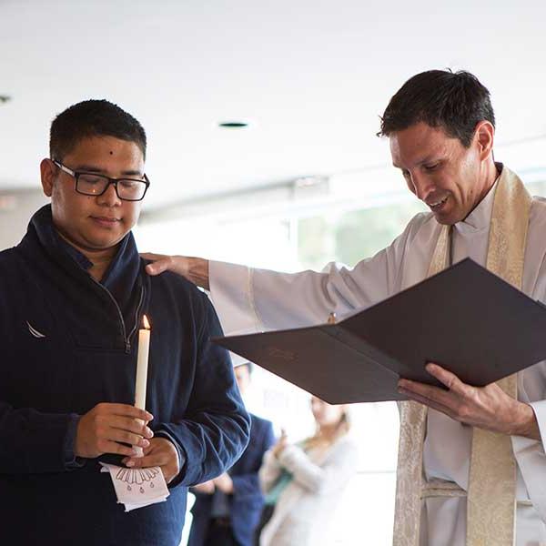 Student preparing to get baptised by campus pastor